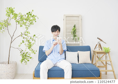 man using smartphone at home 110524477