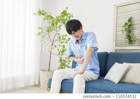 A man with stomach pain at home A man with stomach pain at home 110524532