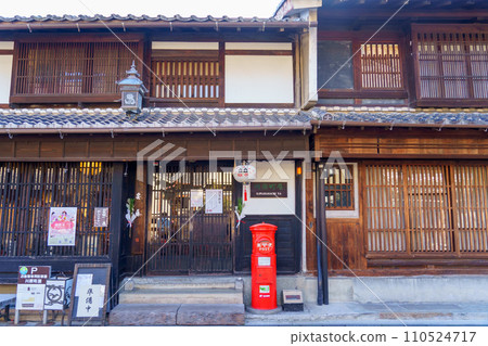 A tenement house with a red mailbox 110524717