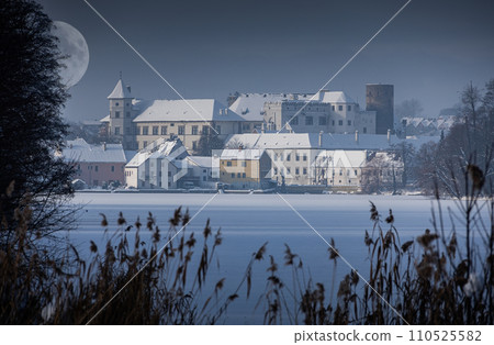 Night in Jindrichuv Hradec - tNight in Jindrichuv Hradec - town covered with snow with lake on foreground and moon on sky, Czechia, Europeown covered with snow with lake on foreground, Czechia, Europe Night in Jindrichuv Hradec - tNight in Jindrichuv Hradec - town covered with snow with lake on foreground and moon on sky, Czechia, Europeown covered with snow with lake on foreground, Czechia, Europe 110525582