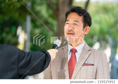 A man responding to an interview on the street 110525952