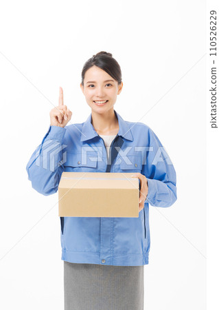 A woman in work clothes carrying luggage 110526229