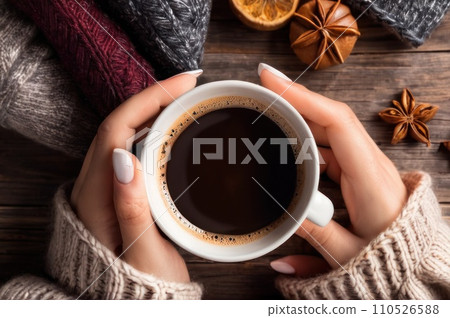 Woman holding cup of hot coffee on rustic wooden table, closeup photo of hands in warm sweater with mug, winter morning concept, top view. AI Woman holding cup of hot coffee on rustic wooden table, closeup photo of hands in warm sweater with mug, winter morning concept, top view. AI 110526588