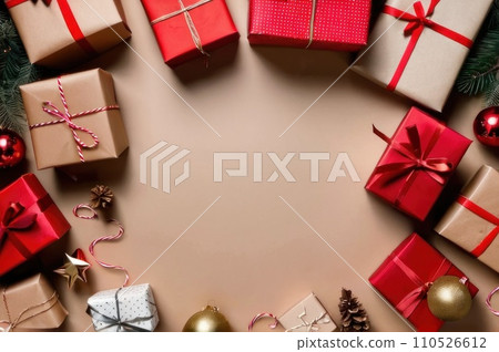 Winter Holidays Concept, Christmas Gifts Wrapped in Craft Paper with Red and Golden Ribbon, Top View. Overhead view of many Christmas presents wrapped with craft paper on paper surface. Copy space. AI 110526612