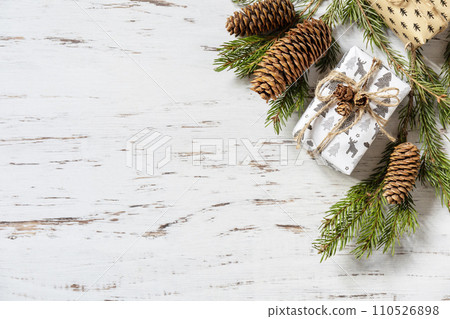 Christmas background. Present boxs and christmas gold decor on a white wood background. View from above. Copy space. 110526898