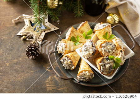 Creative appetizers christmas. Lavash roll cone with chicken and mushroom salad on a plate. Copy space. 110526904