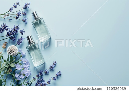 Minimalist beauty product arrangement, fine fragrance bottles with lavender accents, on a uniform light blue background Minimalist beauty product arrangement, fine fragrance bottles with lavender accents, on a uniform light blue background 110526989
