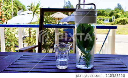 A pot with long life grass and rosemary placed on an outdoor desk A pot with long life grass and rosemary placed on an outdoor desk 110527510