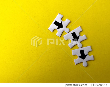 Top view white puzzle with arrow icon on a yellow background. Top view white puzzle with arrow icon on a yellow background. 110528354