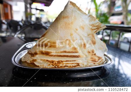 Roti Tisu or Tissue Bread is crunchy form of bread served at mamak restaurant in Malaysia Roti Tisu or Tissue Bread is crunchy form of bread served at mamak restaurant in Malaysia 110528472