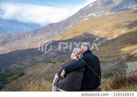 In the mountains, a couple in love enjoying the view of the landscape 110528919