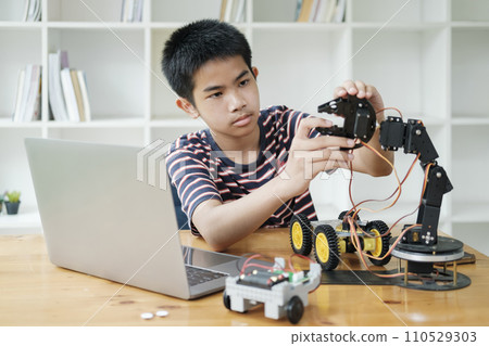 Asian teenager doing robot project in science classroom. technology of robotics programing and STEM education concept. 110529303
