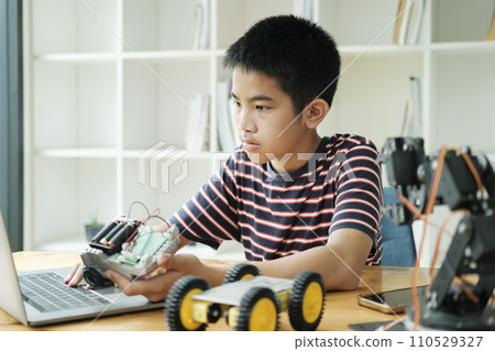 Asian teenager doing robot project in science classroom. technology of robotics programing and STEM education concept. Asian teenager doing robot project in science classroom. technology of robotics programing and STEM education concept. 110529327