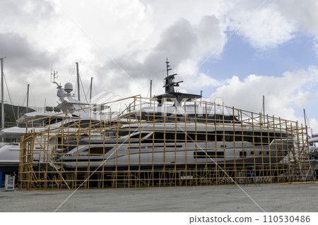 Luxury super yacht ashore on ship repairing yard. Yard period. Repairing. Motor yacht. 110530486