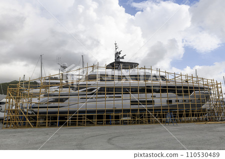 Luxury super yacht ashore on ship repairing yard. Yard period. Repairing. Motor yacht. Luxury super yacht ashore on ship repairing yard. Yard period. Repairing. Motor yacht. 110530489