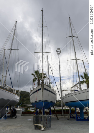 Sailing yacht ashore on ship repairing yard. Yard period. Repairing. 110530494