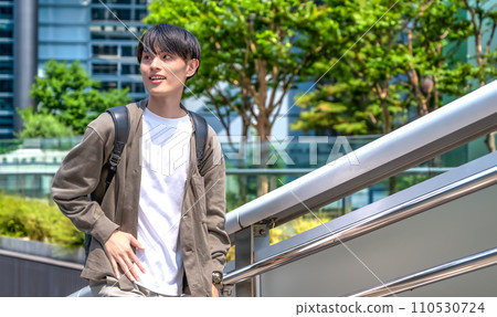 Office casual young businessman in front of Shinbashi station 110530724