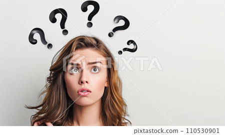 Portrait of a woman with perplexed facial expression; some black question marks above her head 110530901
