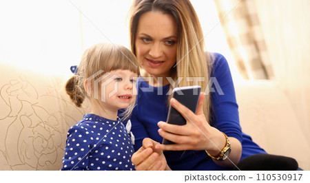 Cute little girl on floor carpet with mom 110530917