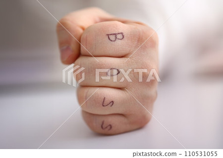 Male clenched fist in suit at office closeup Male clenched fist in suit at office closeup 110531055