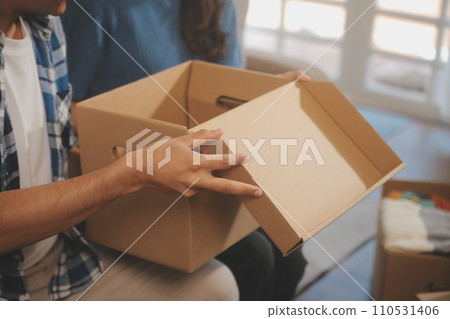 Two Asian blogger showing clothes in front of the camera to recording vlog video live streaming at her shop. Online Shopping Cart notion. on sofa at home Two Asian blogger showing clothes in front of the camera to recording vlog video live streaming at her shop. Online Shopping Cart notion. on sofa at home 110531406