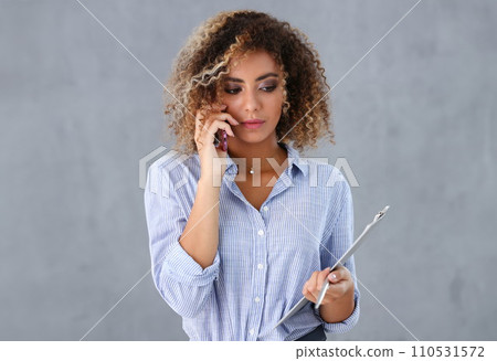 Beautiful black woman portrait. Holds a clipboard 110531572