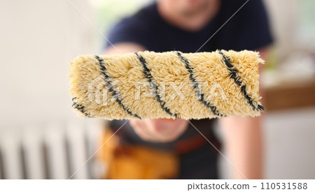 Arm of smiling worker hold brush closeup 110531588