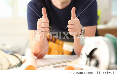 Arm of worker show confirm sign with thumb up 110531601