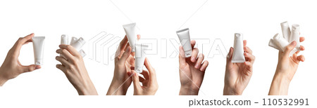 Hand holding cream tubes mockups, beauty product packages, cosmetic packs isolated on white, set 110532991
