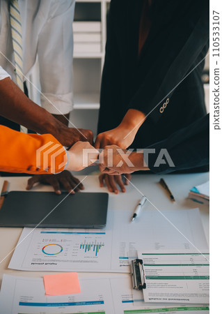 Large business team showing unity with their hands together Large business team showing unity with their hands together 110533107