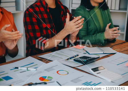 Cheerful business colleagues applauding in meeting at coworking office 110533141