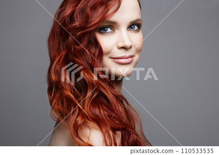 beautiful smiling woman with curly red hair. beauty portrait beautiful smiling woman with curly red hair. beauty portrait 110533535