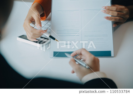 Closeup asian male people car salesman or sales manager offers to sell a car and explains and reads the terms of signing a car contract and insurance. 110533784