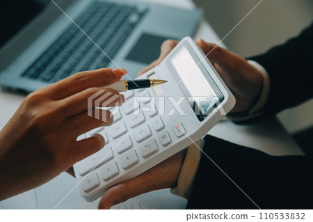 Closeup asian male people car salesman or sales manager offers to sell a car and explains and reads the terms of signing a car contract and insurance. 110533832