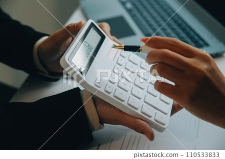 Closeup asian male people car salesman or sales manager offers to sell a car and explains and reads the terms of signing a car contract and insurance. 110533833