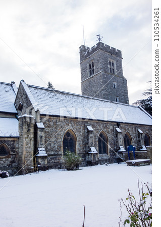 Historic stone church covered in snow, cityscape on the outskirts of London Historic stone church covered in snow, cityscape on the outskirts of London 110534261