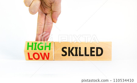High or low skilled symbol. Concept words High skilled or Low skilled on beautiful wooden blocks. Beautiful white background. Businessman hand. Business high or low skilled concept. Copy space. High or low skilled symbol. Concept words High skilled or Low skilled on beautiful wooden blocks. Beautiful white background. Businessman hand. Business high or low skilled concept. Copy space. 110534410