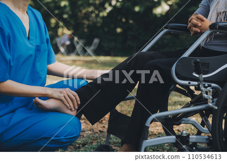 young asian physical therapist working with senior woman on walking with a walker 110534613