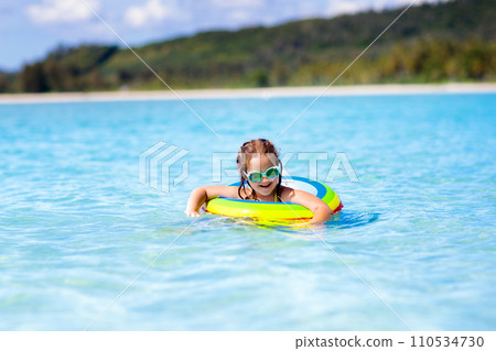 Child on tropical beach. Sea vacation with kids. 110534730