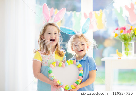Kids on Easter egg hunt. Children dye eggs. Kids on Easter egg hunt. Children dye eggs. 110534739
