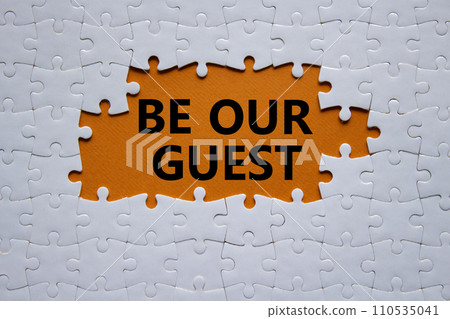 Be our guest symbol. Concept words Be our guest on white puzzle. Beautiful orange background. Business and Be our guest concept. Copy space 110535041
