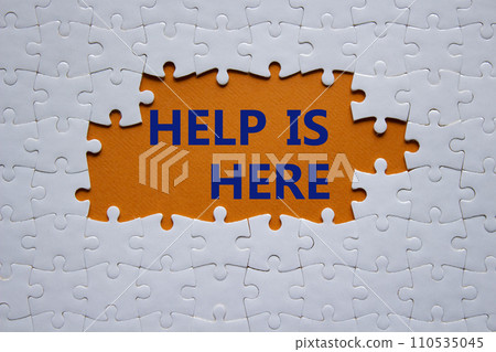 Help is here symbol. Concept words Help is here on white puzzle. Beautiful orange background. Business and Help is here concept. Copy space. Help is here symbol. Concept words Help is here on white puzzle. Beautiful orange background. Business and Help is here concept. Copy space. 110535045