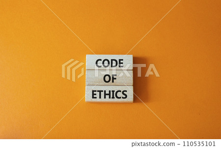 Code of ethics symbol. Concept words Code of ethics on wooden blocks. Beautiful orange background. Business and Code of ethics concept. Copy space. Code of ethics symbol. Concept words Code of ethics on wooden blocks. Beautiful orange background. Business and Code of ethics concept. Copy space. 110535101