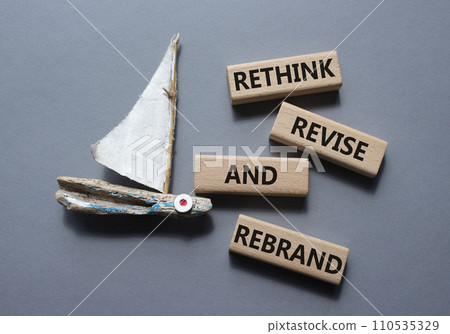 Rethink Revise and Rebrand symbol. Wooden blocks with words Rethink Revise and Rebrand. Beautiful grey background with boat. Business and Rethink Revise and Rebrand concept. Copy space. 110535329
