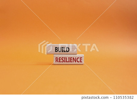Build resilience symbol. Wooden blocks with words Build resilience. Beautiful orange background. Business and Build resilience concept. Copy space. 110535382