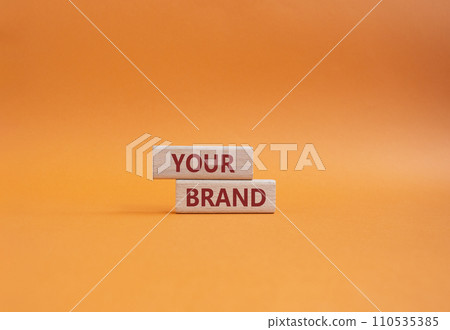 Your Brand symbol. Concept word Your Brand on wooden blocks. Beautiful orange background. Business and Your Brand concept. Copy space 110535385