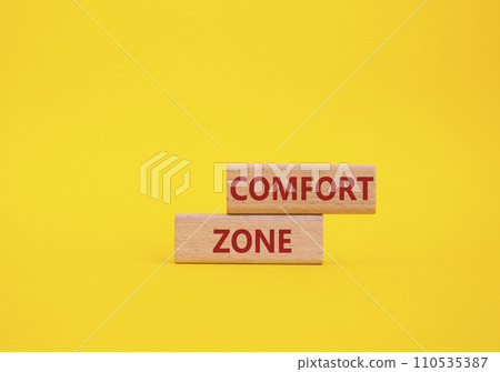 Comfort zone symbol. Concept word Comfort zone on wooden blocks. Beautiful yellow background. Business and Comfort zone concept. Copy space Comfort zone symbol. Concept word Comfort zone on wooden blocks. Beautiful yellow background. Business and Comfort zone concept. Copy space 110535387