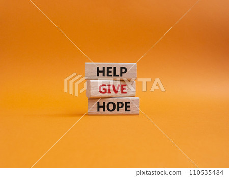Help Give Hope symbol. Concept words Help Give Hope on wooden blocks. Beautiful orange background. Business and Help Give Hope concept. Copy space. 110535484
