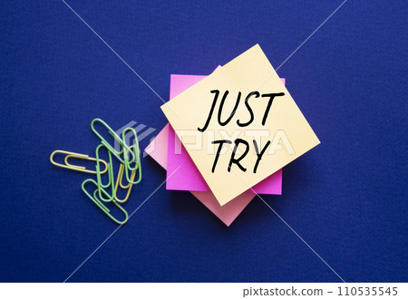 Just try symbol. Orange steaky note with words Just try. Beautiful deep blue background. Business and Just Try concept. Copy space. Just try symbol. Orange steaky note with words Just try. Beautiful deep blue background. Business and Just Try concept. Copy space. 110535545