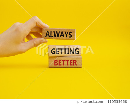 Always getting better symbol. Wooden blocks with words Always getting better. Beautiful yellow background. Businessman hand. Business and Always getting better concept. Copy space. Always getting better symbol. Wooden blocks with words Always getting better. Beautiful yellow background. Businessman hand. Business and Always getting better concept. Copy space. 110535668